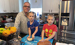 David Turner and his kids baking bread in their kitchen